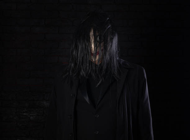 man in scary mask with bulging eyes and black hair