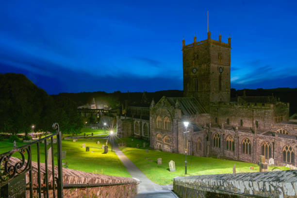 istock Pembroke Wales - August 3 2024;  Night scene overlooking St David's Cathedral with grounds illuminayed and dark blue sky overhead. 2192303151