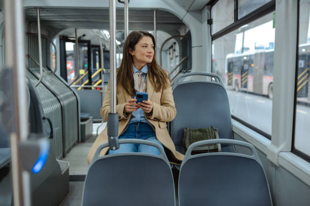 istock Woman on public transit seated calmly and using a phone 2192304449