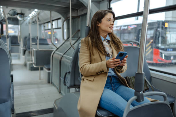 istock Woman using a smartphone while riding on a public transportation bus 2192304456