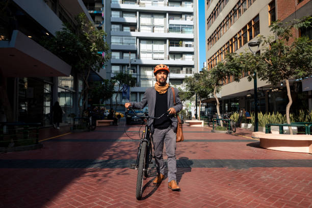 Male bicycle messenger rushing down the city street to make the delivery on right time.