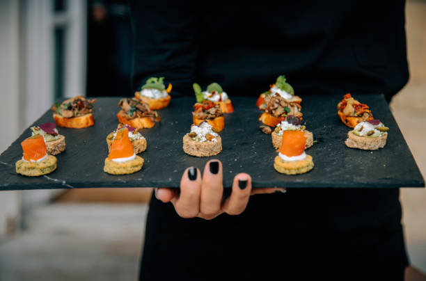 istock Waiter carrying plates for canape service 2192308329