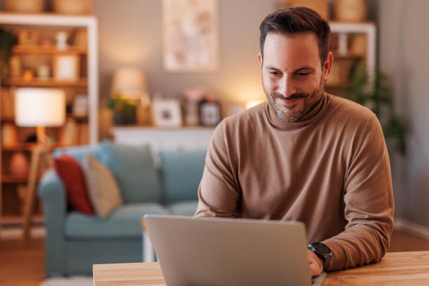 istock Portrait of focused freelancer developing software over laptop while working at desk in home office 2192309462