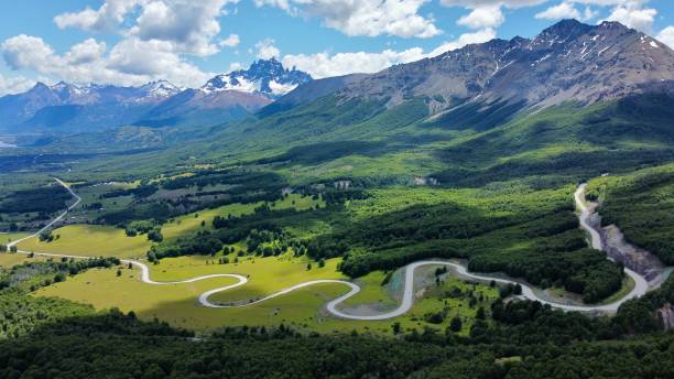 “Carretera Austral with Cerro Castillo and Its Snow-Capped Peaks in the Background” “Impressive aerial view of the Carretera Austral winding through the lush green landscapes of Chilean Patagonia, with the magnificent Cerro Castillo and its snow-capped peaks as the stunning backdrop. Perfect for tourism, adventure, and nature projects.” carretera austral chile stock pictures, royalty-free photos & images