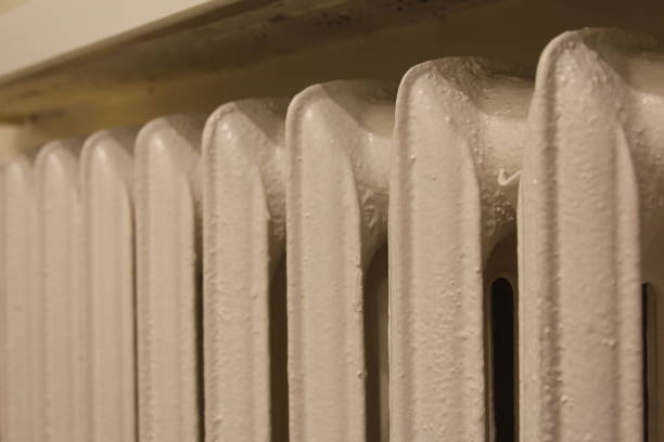 istock Heating system with condensation on radiator in cozy indoor setting 2192311603