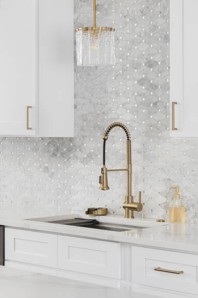 istock A kitchen with a gold faucet and tiled backsplash. 2192312660