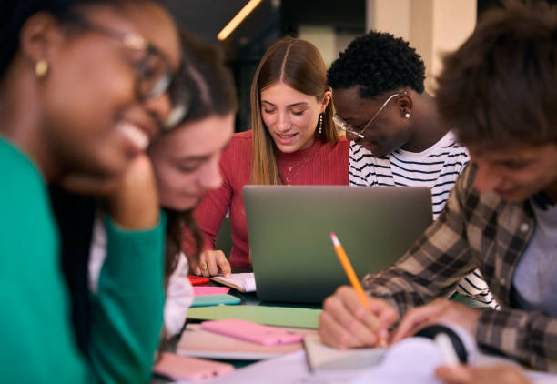 istock Selective focus on multiracial couple of concentrated students doing homework 2192313379
