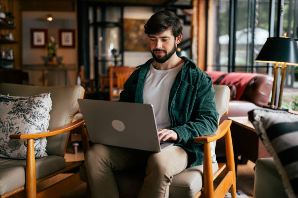 istock Young man working remotely in the living room 2192318435