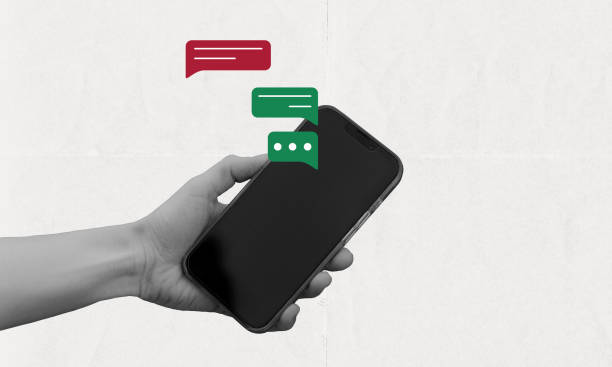 istock Hand holding phone with pop up chat bubble, online conversation concept 2192323409