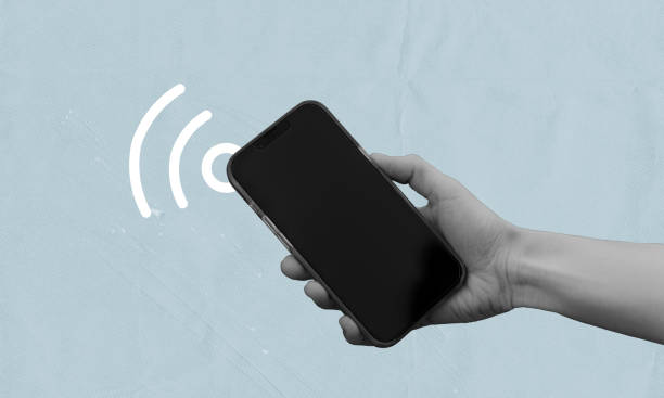 istock Hand holding phone with signal icon, searching for internet wifi connection 2192323410