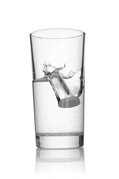 istock Tablet dissolving in a glass of water on white background 2192323779