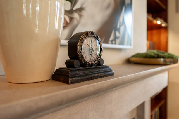 A classic ornate clock sits on a shelf, accentuating the refined decor of a boutique hotel with its antique design and subtle luxury.
