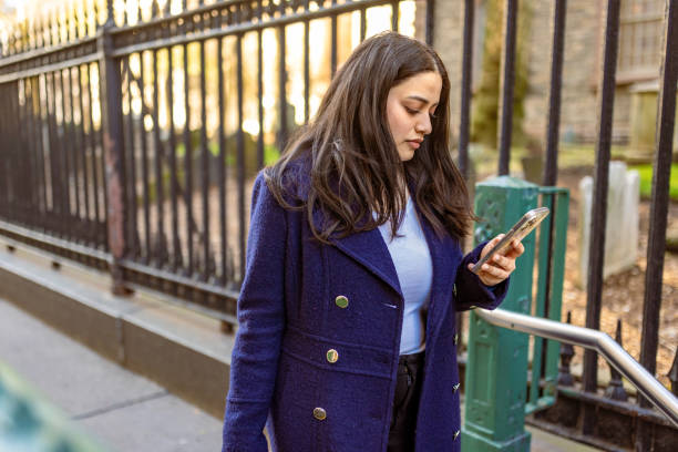 istock Stylish Woman Using Phone in Morning Light 2192324054
