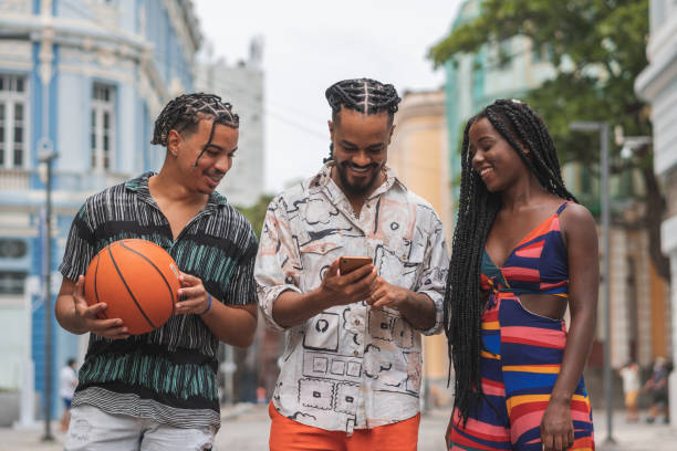 istock Afro friends using smartphone on street 2192328194