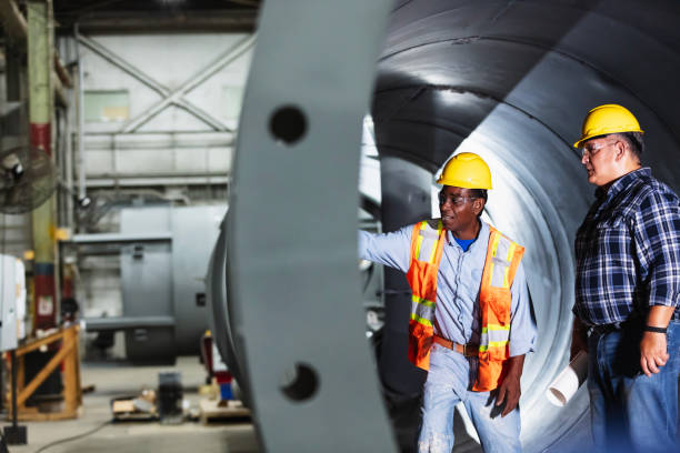istock Two workers in quality control at metal fabrication plant 2192329564