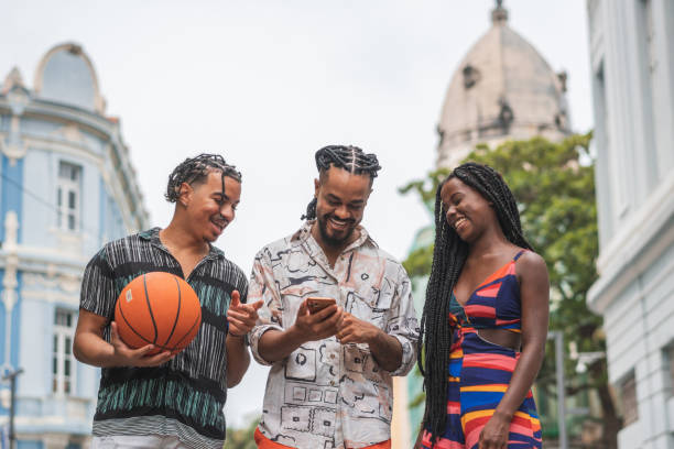 istock Afro friends using smartphone on street 2192330090