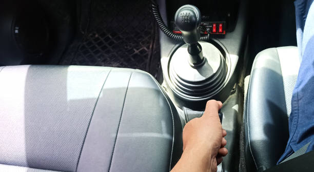 istock Hand pulling the hand brake in car - car interior, Focus on hand break 2192331034