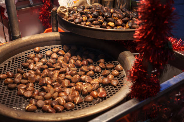 Many ripe chestnuts ready to be grilled on a black cast iron grill