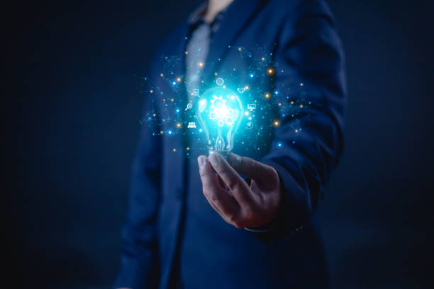 istock Idea innovate and concept. Hand holding a light bulb that shine glitter, creative thinking concept success, management and digital transformation, data search, thinking 2192332800