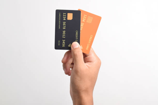 istock Hand holding two credit cards on white background 2192334100
