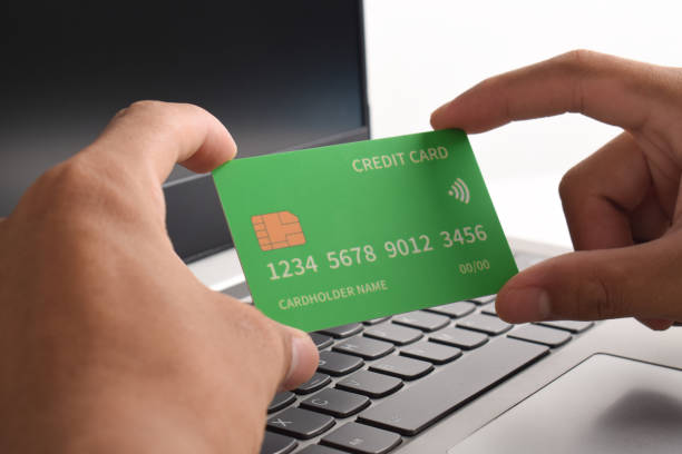 istock Hand holding credit card on laptop 2192337577