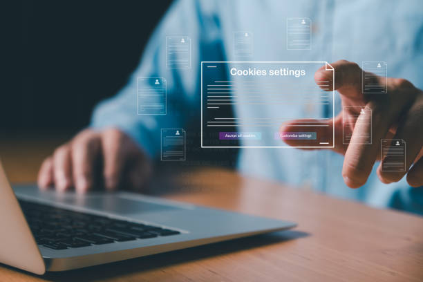 istock hand using laptop while choose to accept internet cookies policy or reject. Customer data privacy concept that allow web browser to collect user data to resell or use for marketing purpose. 2192343950