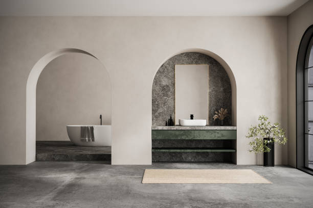 istock Modern minimalist bathroom interior, modern bathroom cabinet, white sink marble countertop, interior plants, bathroom accessories, bathtub, beige walls, concrete floor, arches. 2192348676