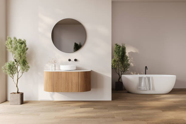 istock Modern bathroom interior with dark brown parquet floor, two sinks, double mirrors, white bathtub, interior plants, 2192348686