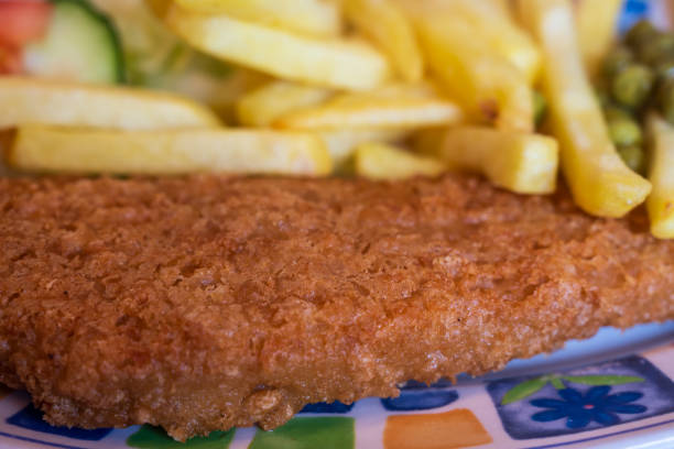 istock closeup of typical british dish - fish and chips on a colorful plate 2192354035