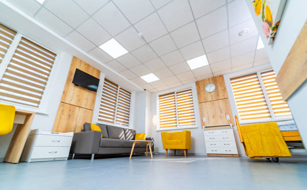 istock Cozy waiting area with modern decor. A bright waiting area features yellow chairs, a sofa, and wooden accents, creating a welcoming atmosphere for visitors. 2192355973