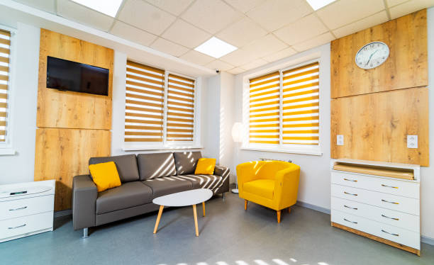 Cozy modern lounge design. Comfortable seating and stylish decor create a welcoming atmosphere in a well-lit lounge area with wooden accents.