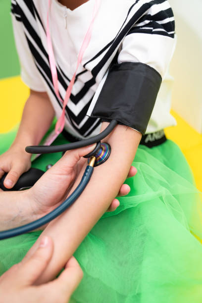 istock Child getting a health checkup. A child is having their blood pressure checked during a routine health checkup at a colorful clinic. 2192355979