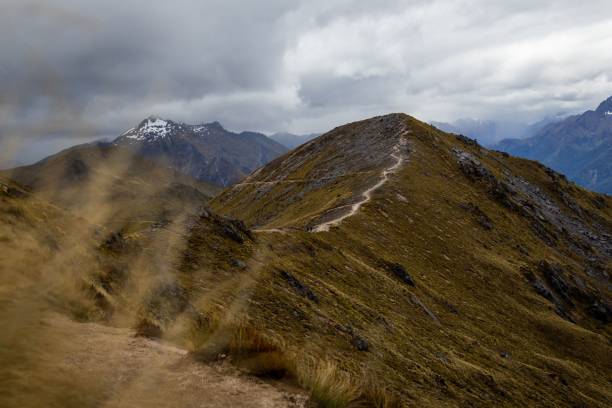 istock Scenic Mountain Trail with Snow-Capped Peaks 2192356081