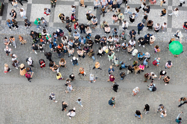 A dense crowd of people in summer viewed from directly above.