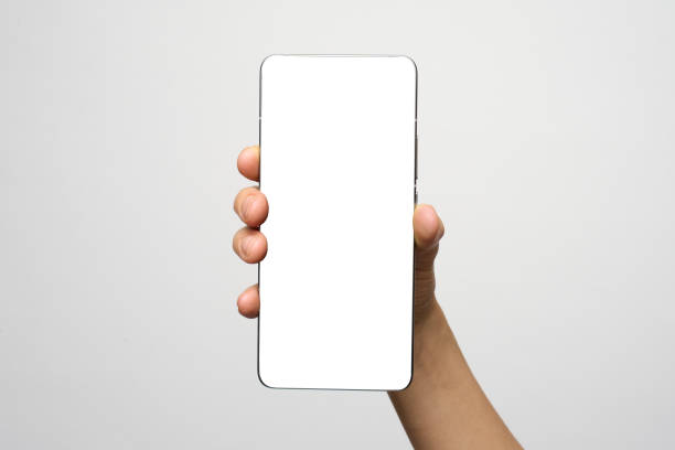 istock Hand with phone on white background with copy space. Woman holding smartphone with white screen. Hand with blank cellphone display, close-up 2192368468