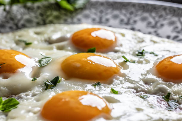 English breakfast on a plate. Ham and eggs sprinkled with parsley.