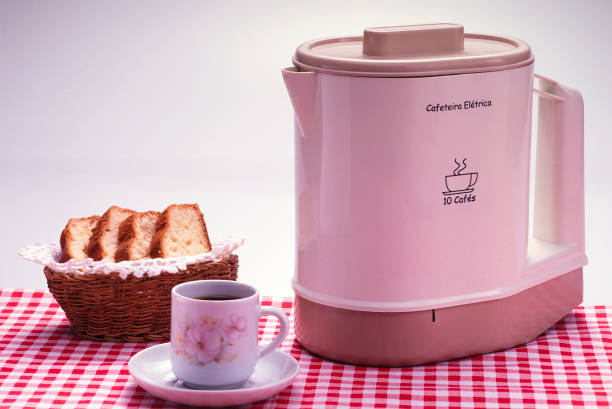 electric coffee maker with cup and toast