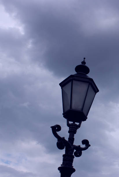 istock Black Metal Post With Decorative Street Light Under Cloudy Sky Vertical Stock Image 2192374443
