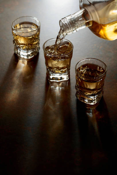 istock Whiskey pour from a bottle into a small glasses. 2192376832
