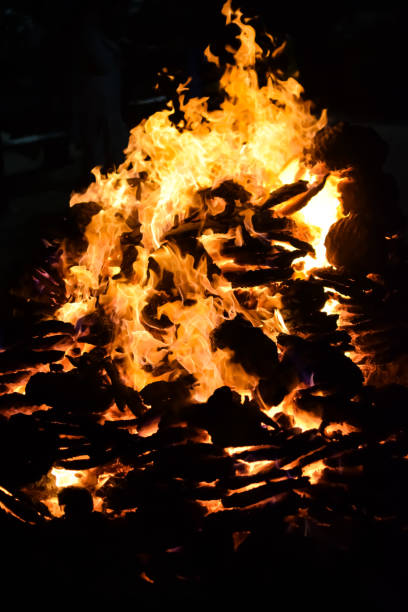 istock Fire flames on black background, Blaze fire flame texture background, Beautifully, the fire is burning, Fire flames with wood and cow dung bonfire 2192377080