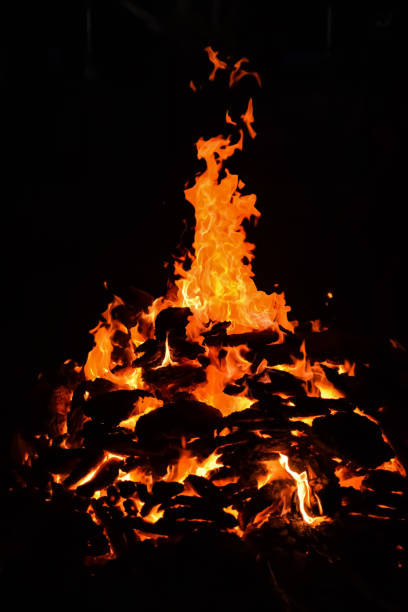 istock Fire flames on black background, Blaze fire flame texture background, Beautifully, the fire is burning, Fire flames with wood and cow dung bonfire 2192377105