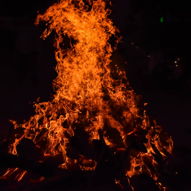 istock Fire flames on black background, Blaze fire flame texture background, Beautifully, the fire is burning, Fire flames with wood and cow dung bonfire 2192377115