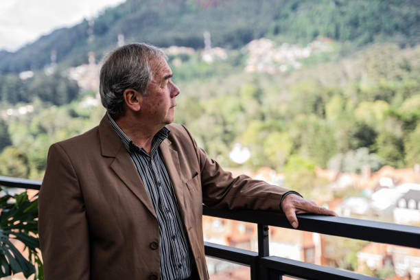 istock Senior man looking at view on apartment's balcony 2192377122