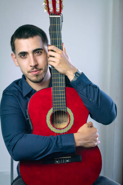 istock Musician hugging his red acoustic guitar with passion 2192381722