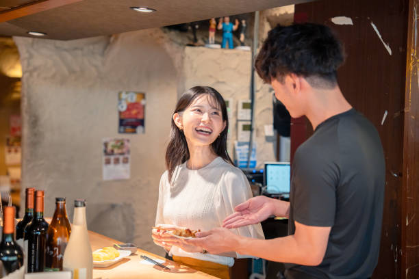 istock Female customers and waitresses at a yakitori restaurant 2192384377