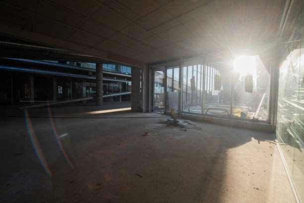 istock A captivating view of a modern business building under construction, showcasing its raw industrial interior with exposed steel beams and concrete walls bathed in the warm, golden hues of a sunset 2192384444