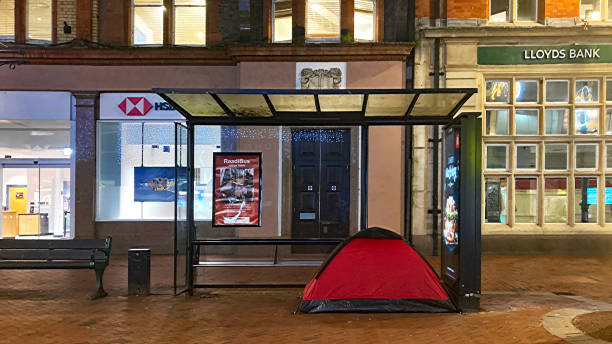 Reading, Berkshire, England, December 28th. 2024: Tent of a homeless person erected under a bus shelter in a town centre.