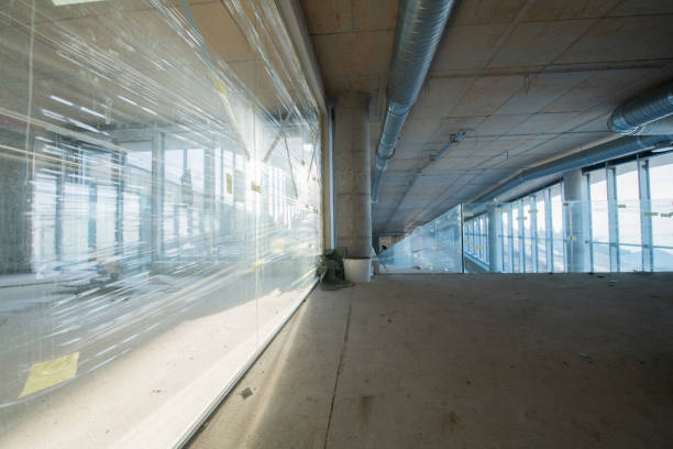 istock A captivating view of a modern business building under construction, showcasing its raw industrial interior with exposed steel beams and concrete walls bathed in the warm, golden hues of a sunset 2192389476