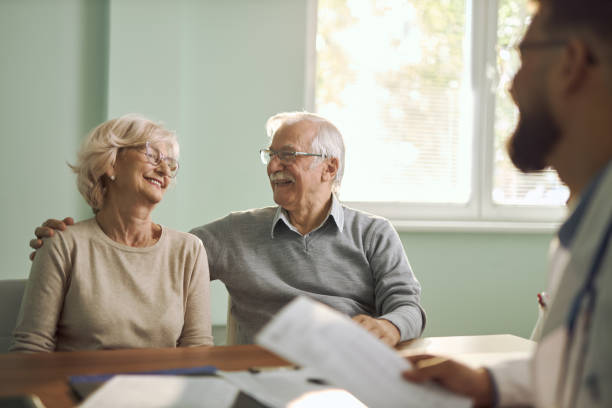 istock Smiling senior couple having an appointment with their doctor 2192389653