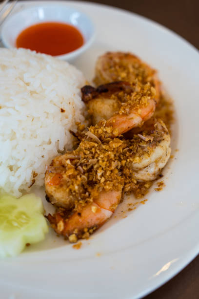 Close up of fried shrimp with garlic and pepper on rice, Thai food style.